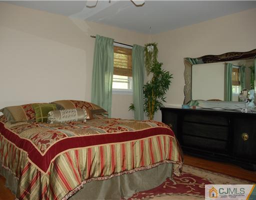 5 Chandler Road Edison, NJ 08820 - Photo 10 of 23 a bedroom with a bed and window