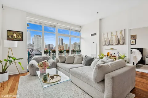 a living room with furniture kitchen and a table