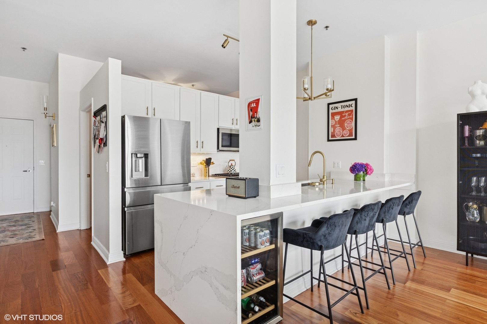 340 West Superior Street, Unit 1607 Chicago, IL 60654 - Photo 9 of 17 a kitchen with stainless steel appliances granite countertop a refrigerator and a dining table