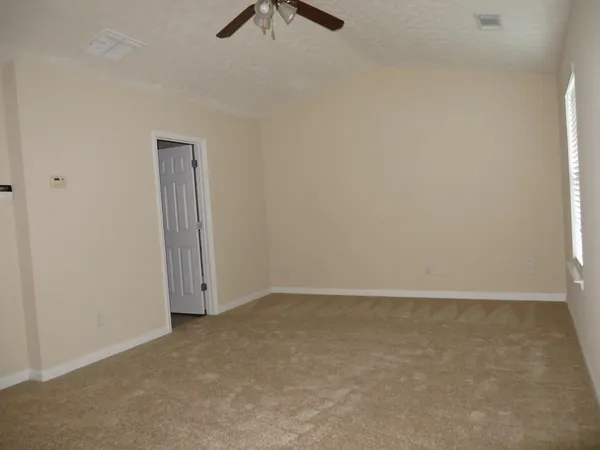 a bathroom with a granite countertop sink a toilet and mirror