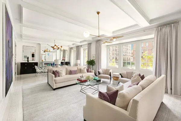a living room with furniture and a chandelier