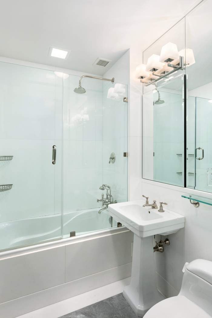 823 Park Avenue, Unit 4 Manhattan, NY 10021 - Photo 12 of 14 a bathroom with a sink vanity tub and shower