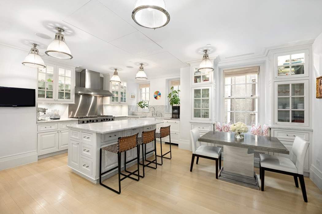 823 Park Avenue, Unit 4 Manhattan, NY 10021 - Photo 5 of 14 a kitchen with sink cabinets and dining table