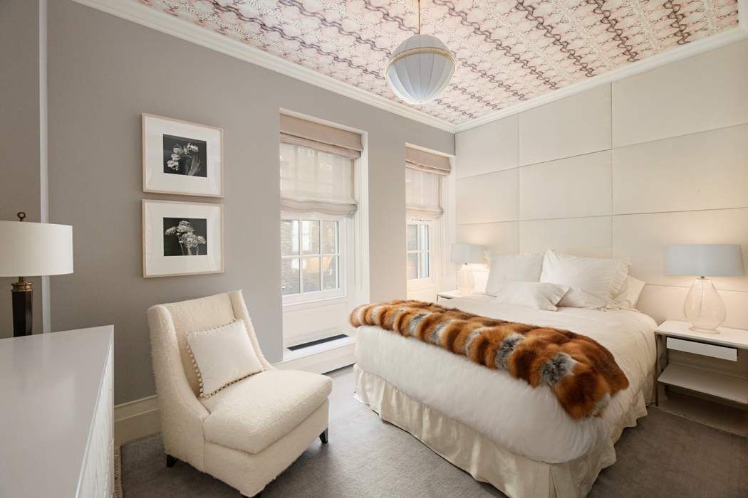 823 Park Avenue, Unit 4 Manhattan, NY 10021 - Photo 9 of 14 a bedroom with a bed and a chandelier