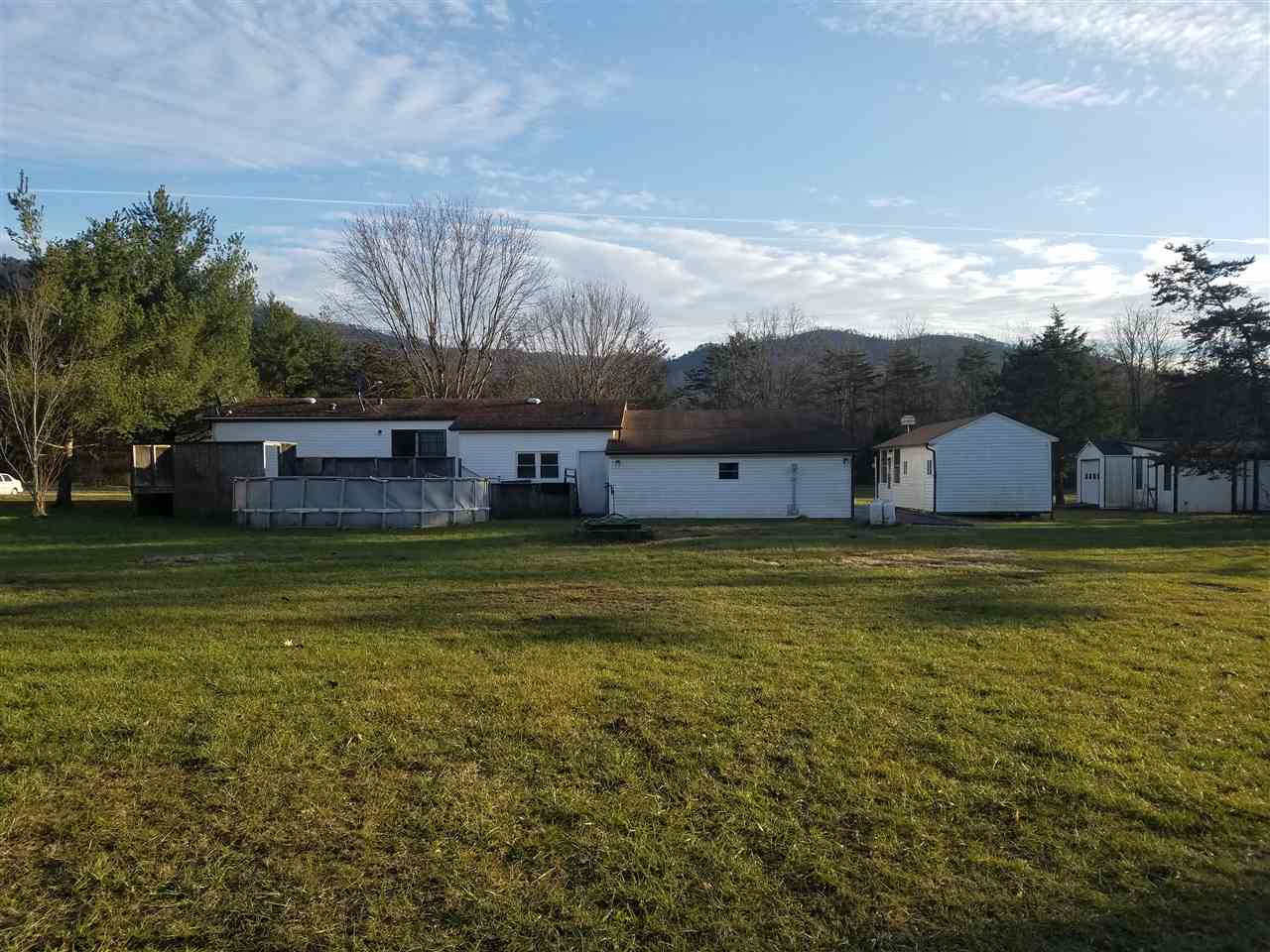 5273 Cold Springs Road Raphine, VA 24472 - Photo 15 of 37 a house view with swimming pool and trees in front of it