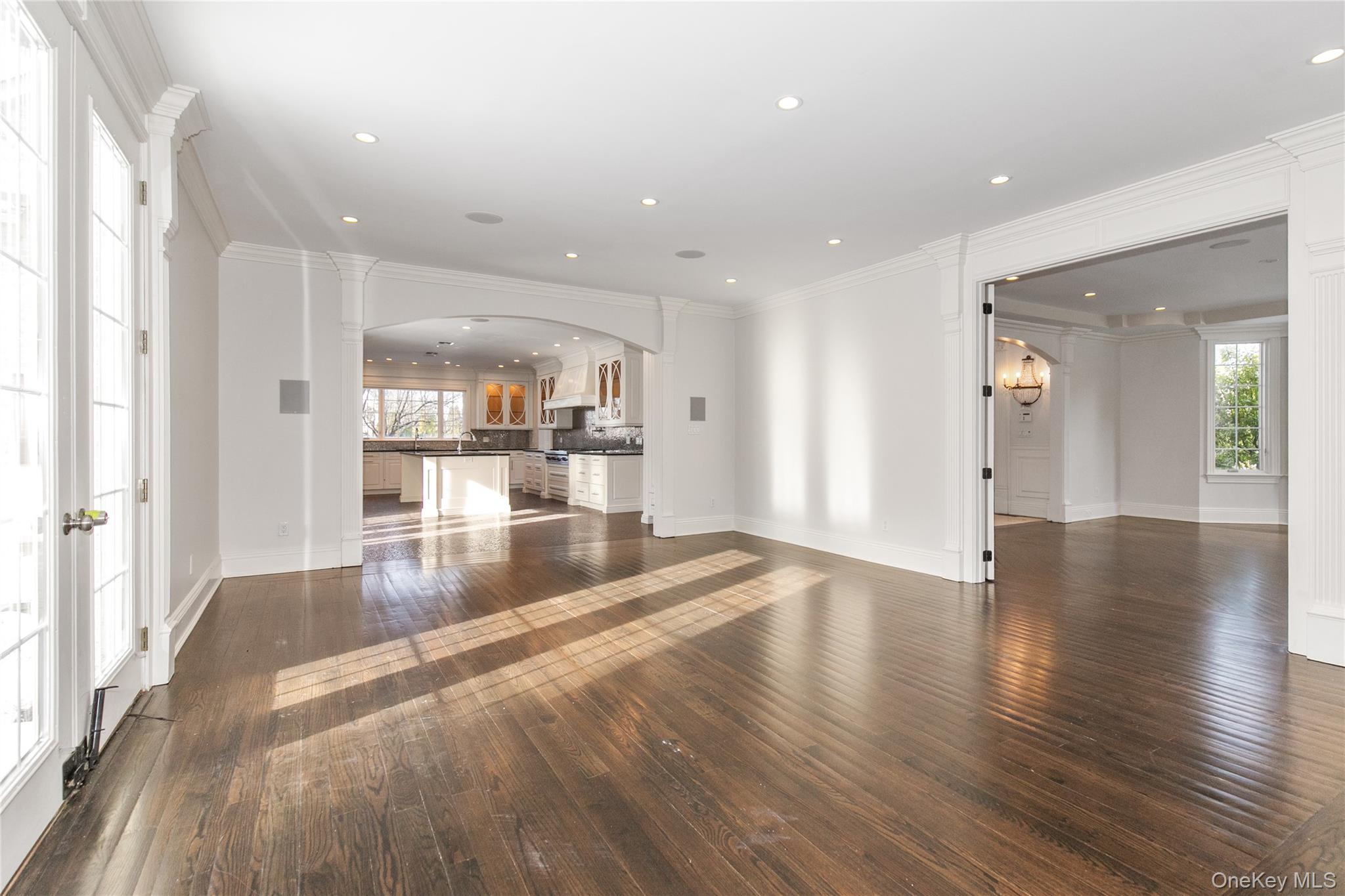 12 Knollwood Road Roslyn, NY 11576 - Photo 11 of 41 a view of a kitchen and an empty room with wooden floor