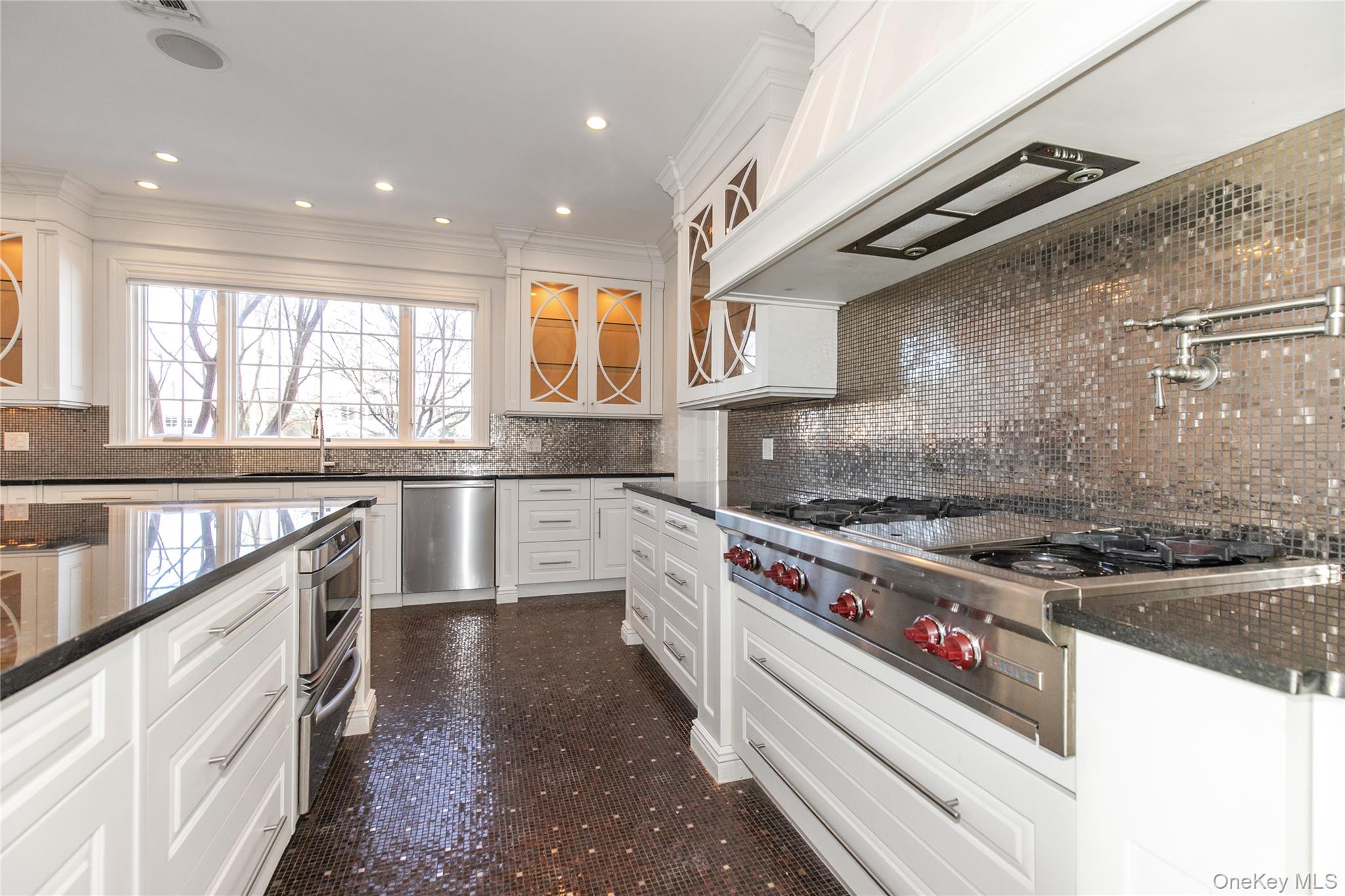 12 Knollwood Road Roslyn, NY 11576 - Photo 14 of 41 a kitchen with stainless steel appliances granite countertop a stove a sink and a refrigerator