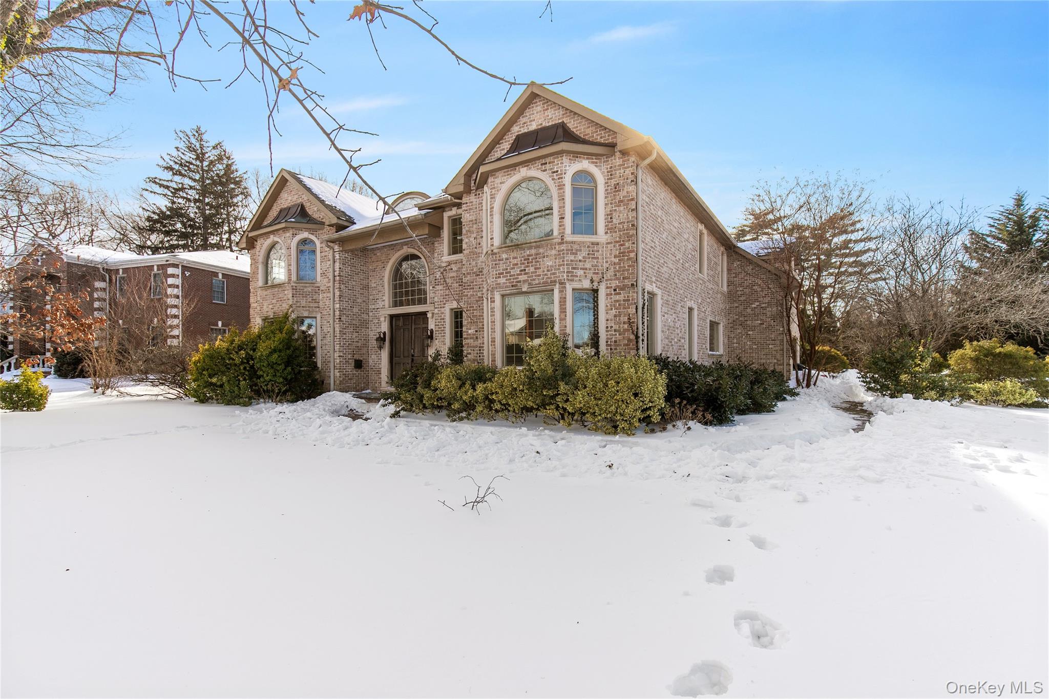 12 Knollwood Road Roslyn, NY 11576 - Photo 2 of 41 a front view of a house with a yard