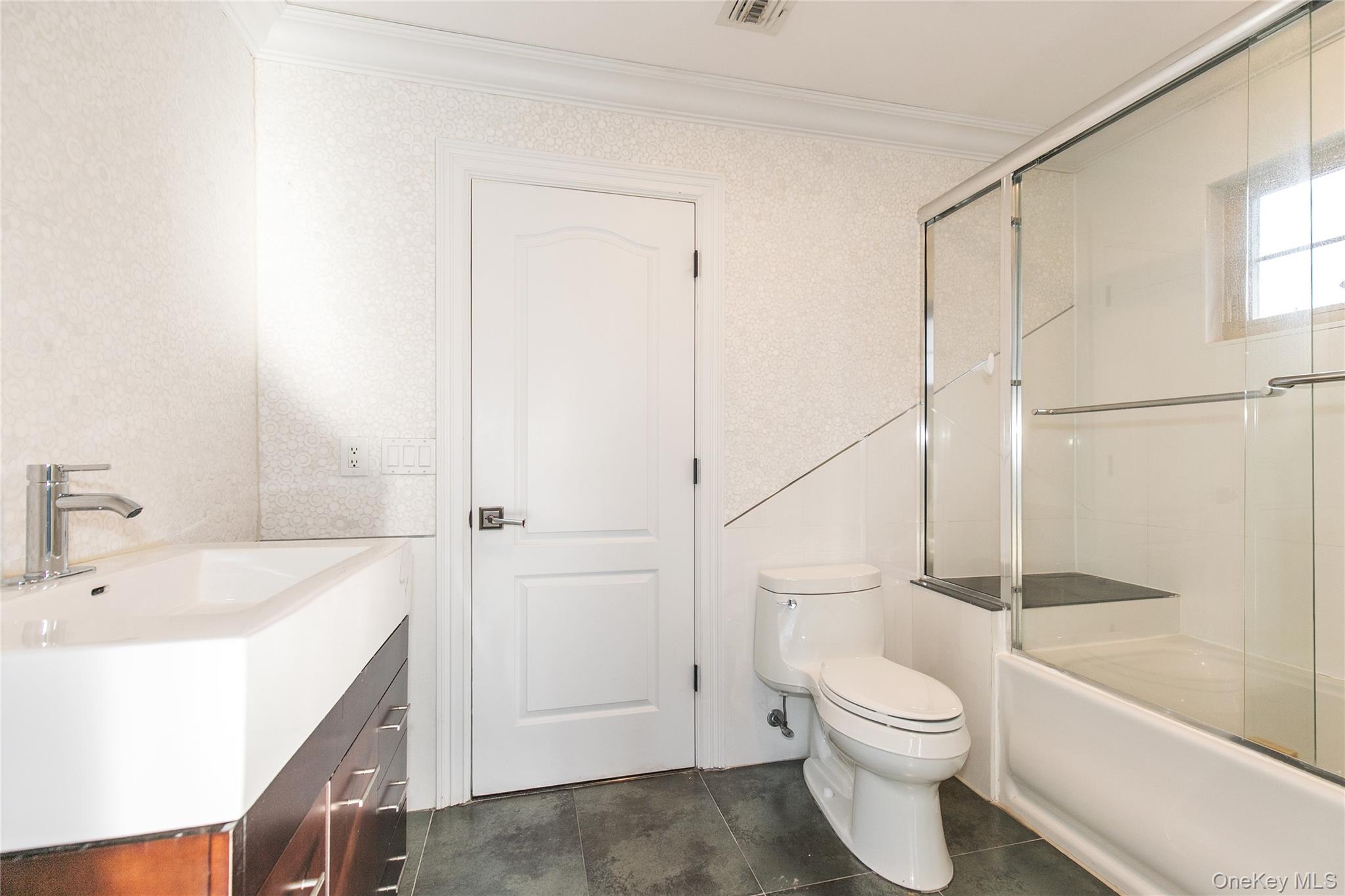 12 Knollwood Road Roslyn, NY 11576 - Photo 29 of 41 a bathroom with a sink a toilet and shower