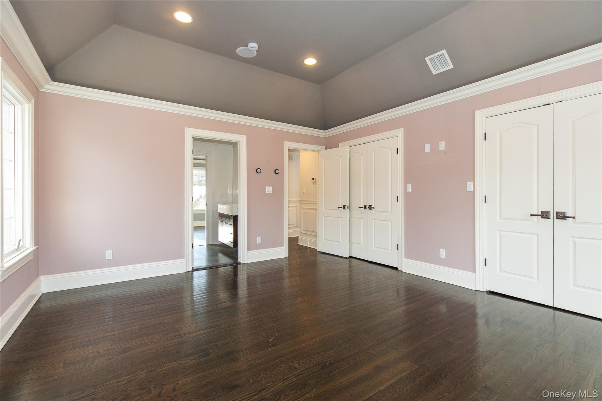 12 Knollwood Road Roslyn, NY 11576 - Photo 31 of 41 an empty room with wooden floor & windows and bathroom