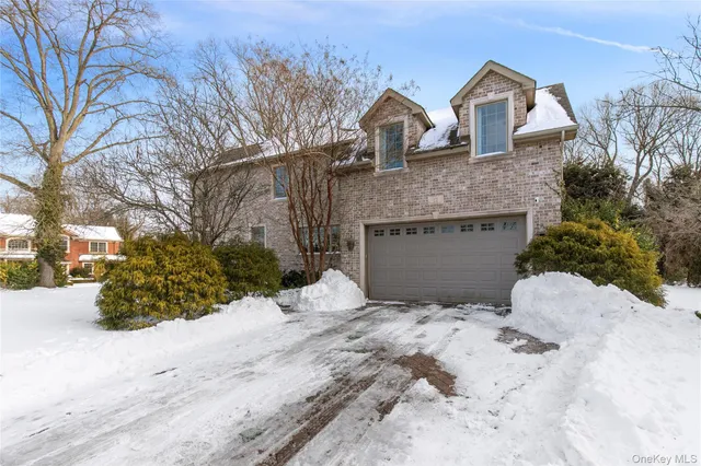 a front view of a house with a yard covered with snow in front of house