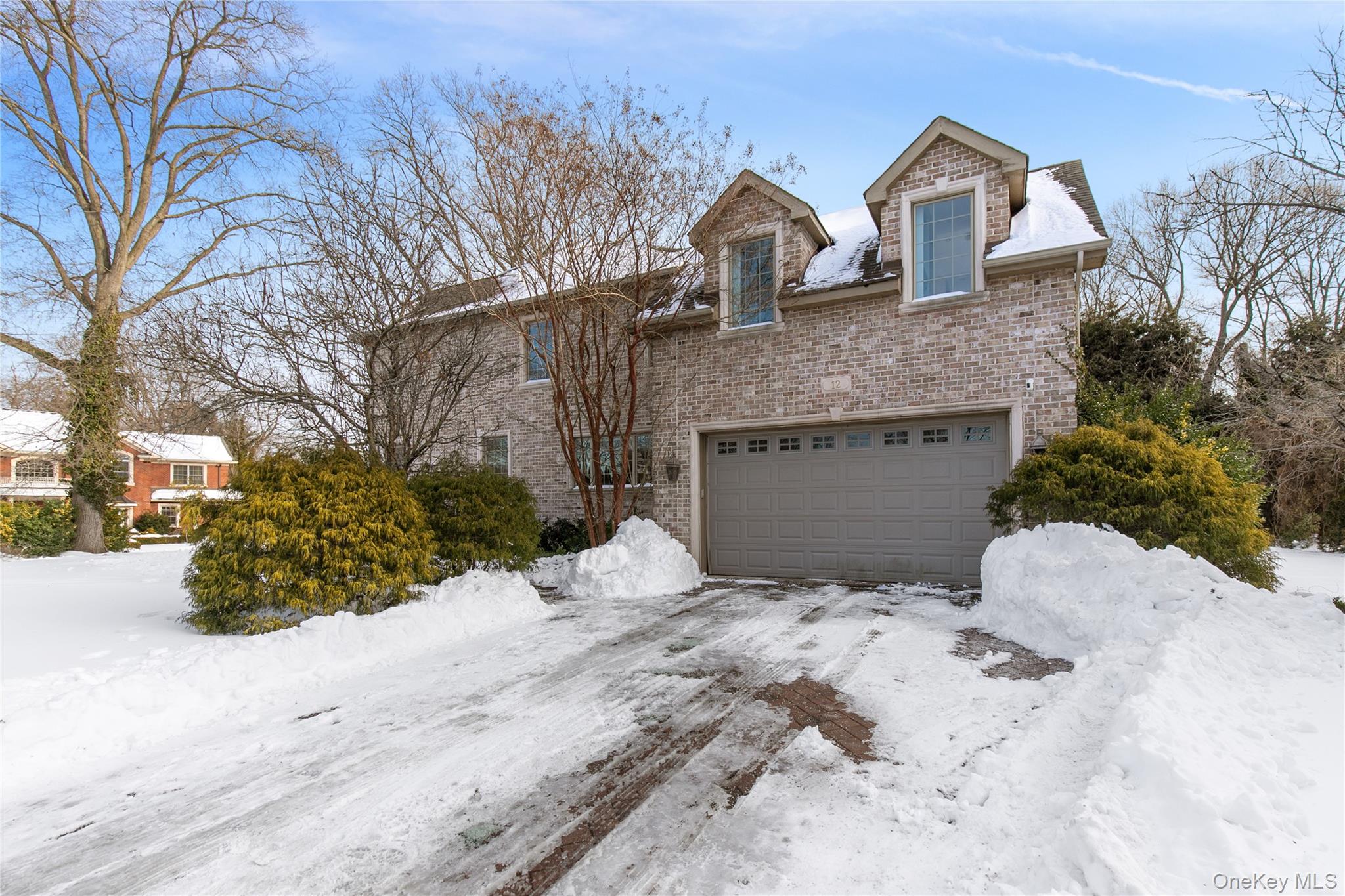 12 Knollwood Road Roslyn, NY 11576 - Photo 38 of 41 a front view of a house with a yard covered with snow in front of house