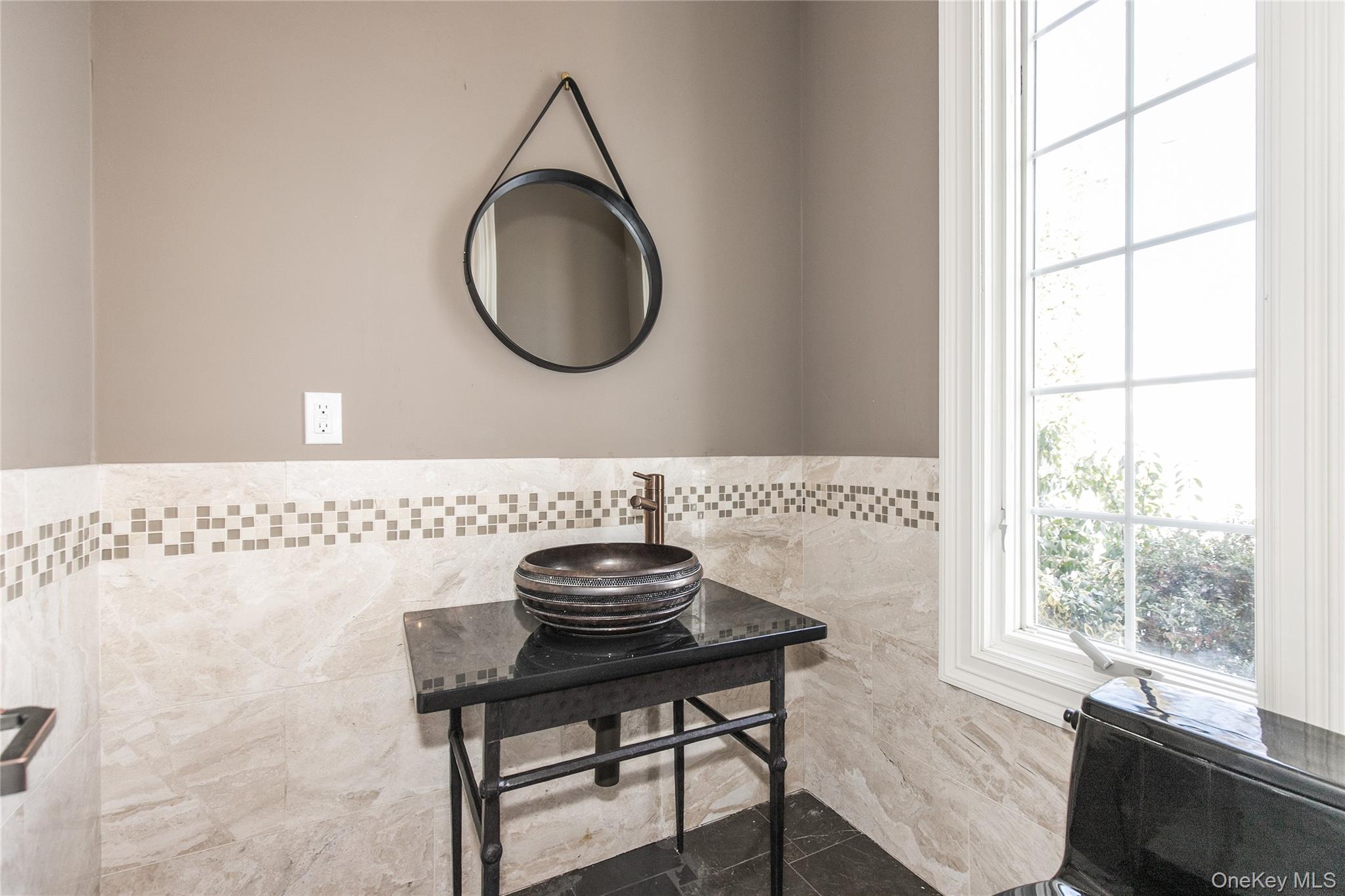 12 Knollwood Road Roslyn, NY 11576 - Photo 4 of 41 a bathroom with a sink a mirror and a window