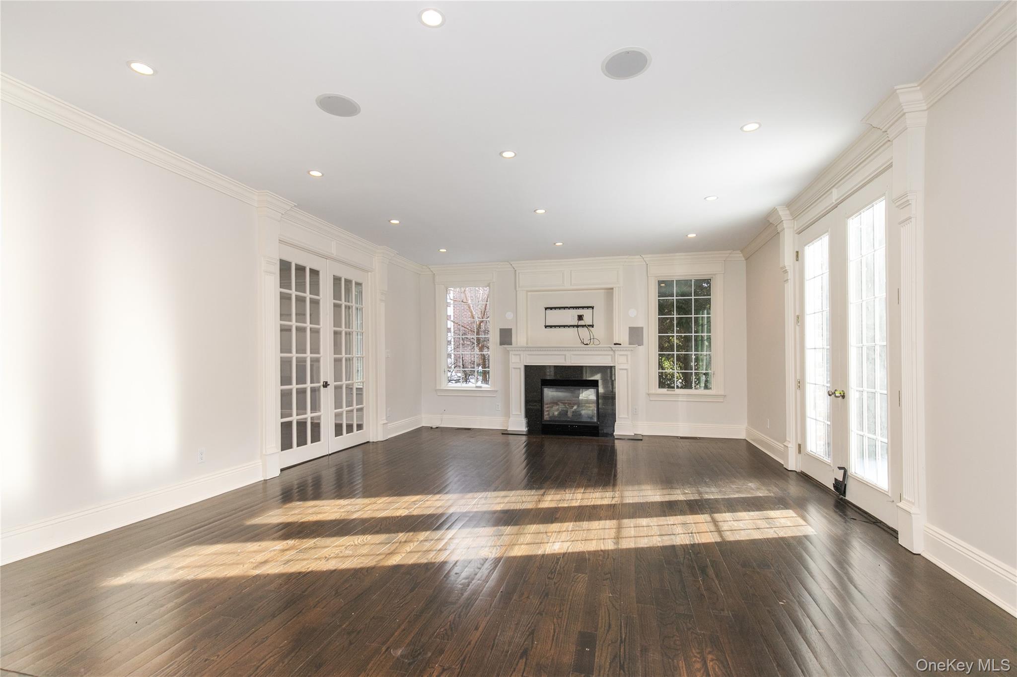 12 Knollwood Road Roslyn, NY 11576 - Photo 9 of 41 a view of an empty room with wooden floor and a window