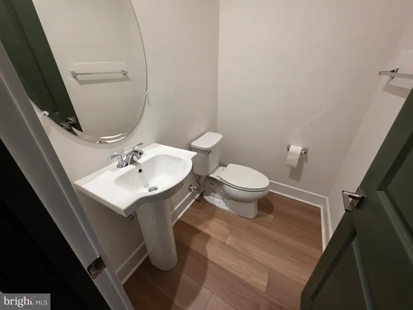 a bathroom with a sink toilet and a mirror