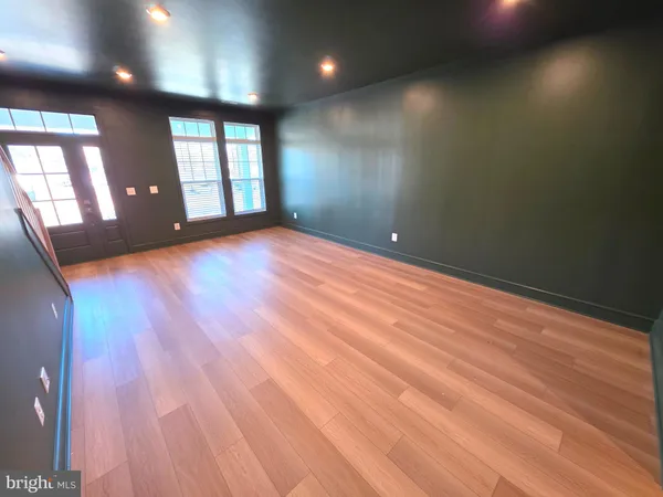 an empty room with entrance and windows