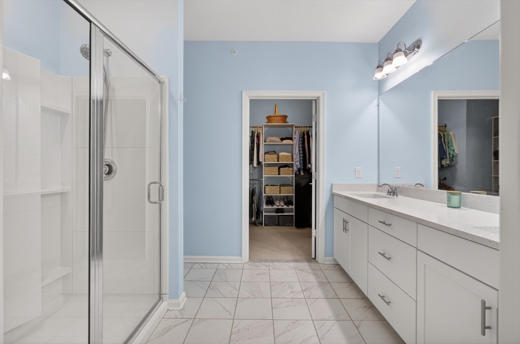 87 Shannon Way, Unit 86 Upton, MA 01568 - Photo 16 of 36 a spacious bathroom with a double vanity sink and a mirror