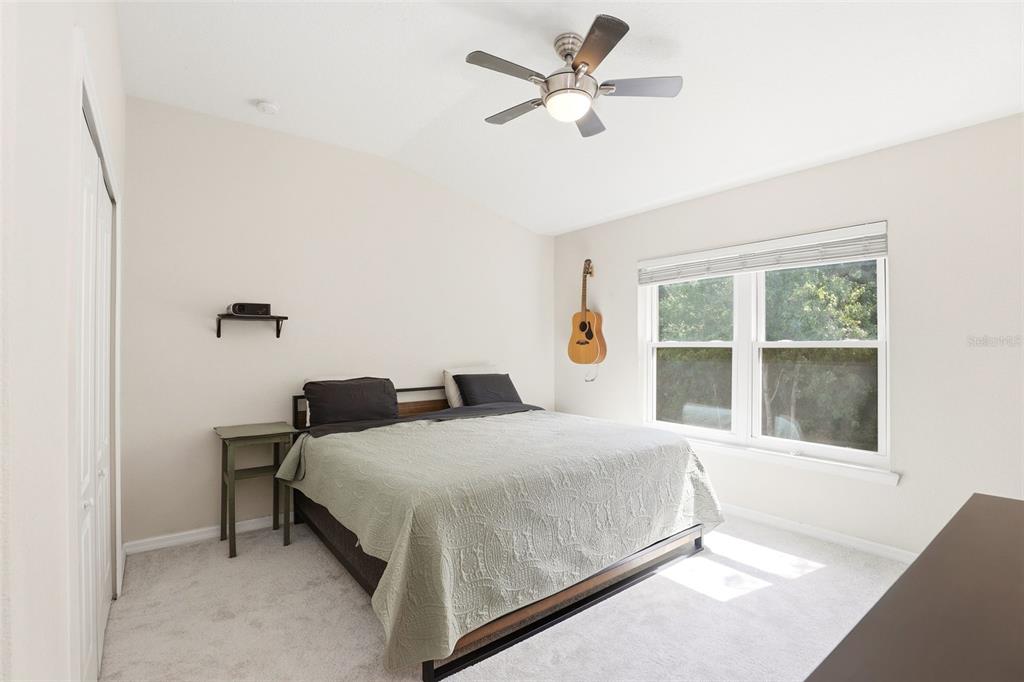 6458 South Goldenrod Road, Unit 29B Orlando, FL 32822 - Photo 19 of 40 a bedroom with a bed next to a window with a chandelier
