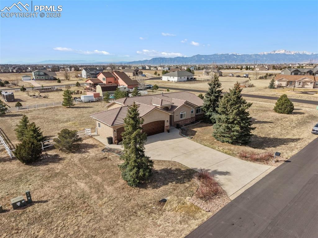 11515 Texarkanna Road Peyton, CO 80831 - Photo 3 of 43 Aerial view of residential area with a mountain backdrop
