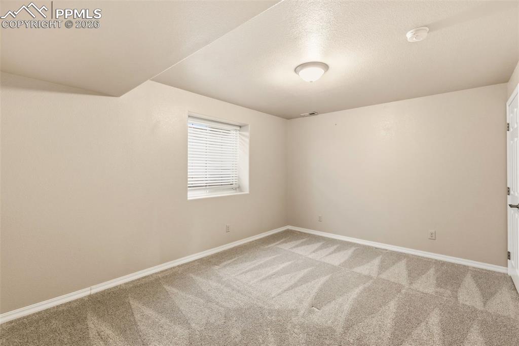 11515 Texarkanna Road Peyton, CO 80831 - Photo 43 of 49 Spare room featuring baseboards and light colored carpet