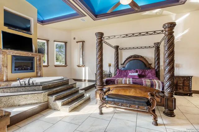 a living room with fireplace furniture and a flat screen tv