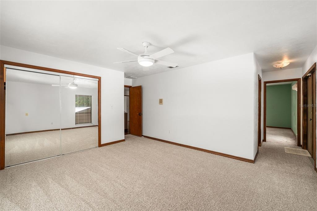 4703 Northwest 124th Street Gainesville, FL 32606 - Photo 27 of 55 an empty room with a bathroom and a ceiling fan