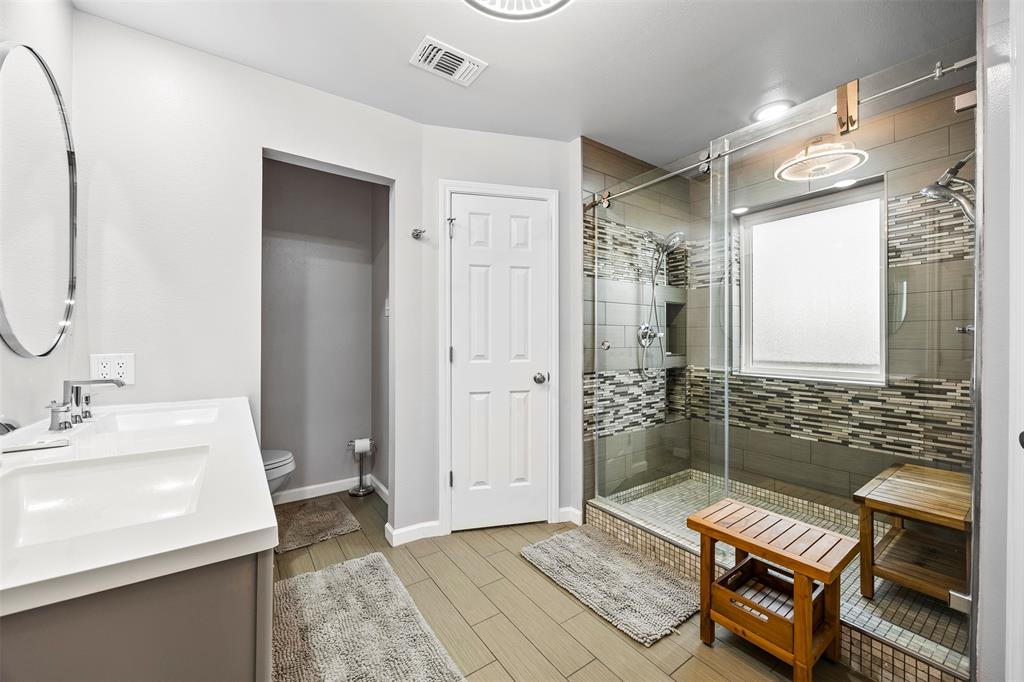 909 Valley View Avenue Red Oak, TX 75154 - Photo 21 of 37 a bathroom with a sink a mirror and a shower