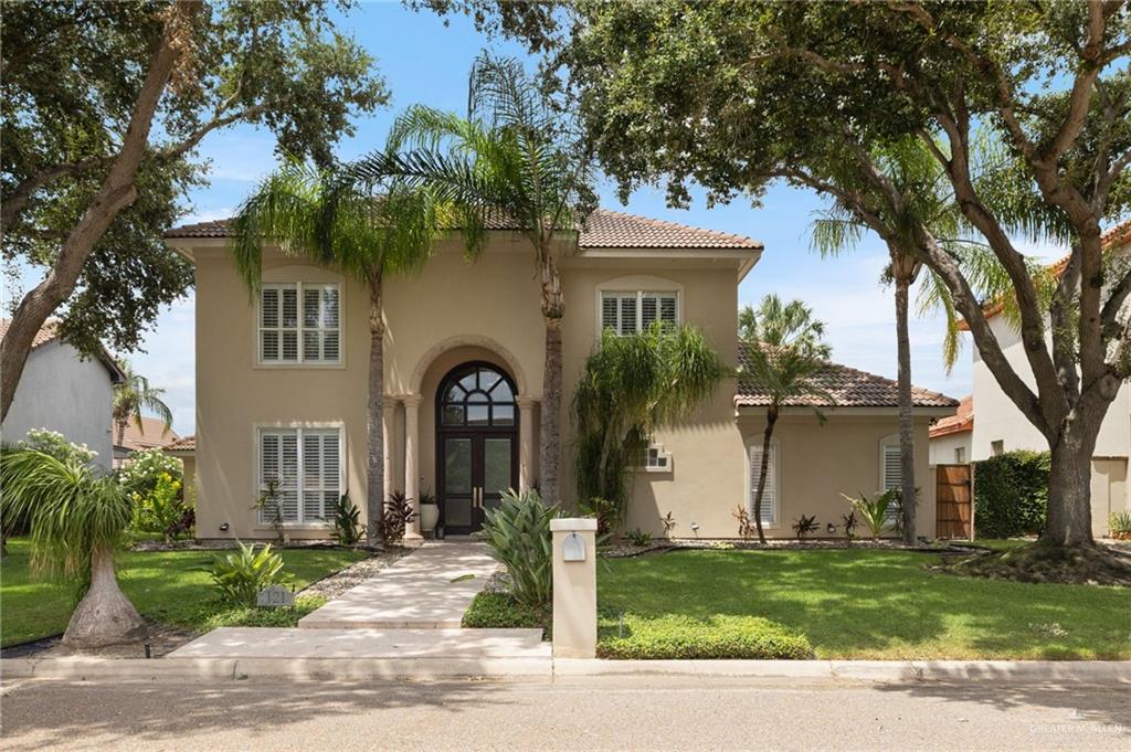 121 Rio Grande Drive Mission, TX 78572 - Photo 1 of 1 Mediterranean / spanish house featuring a tiled roof, stucco siding, french doors, and a front lawn