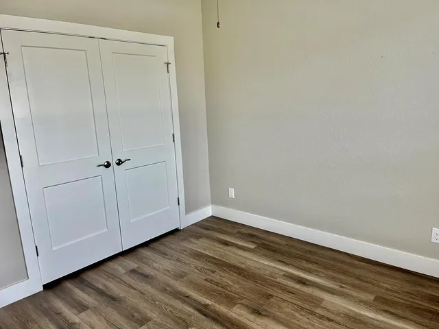 a view of an empty room with closet area