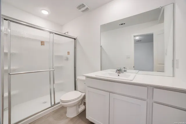 a bathroom with a toilet a sink and a mirror