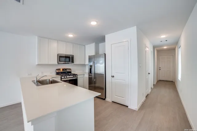 a kitchen with cabinets and stainless steel appliances