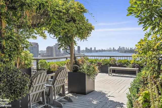 a view of a balcony with chairs and a potted plant