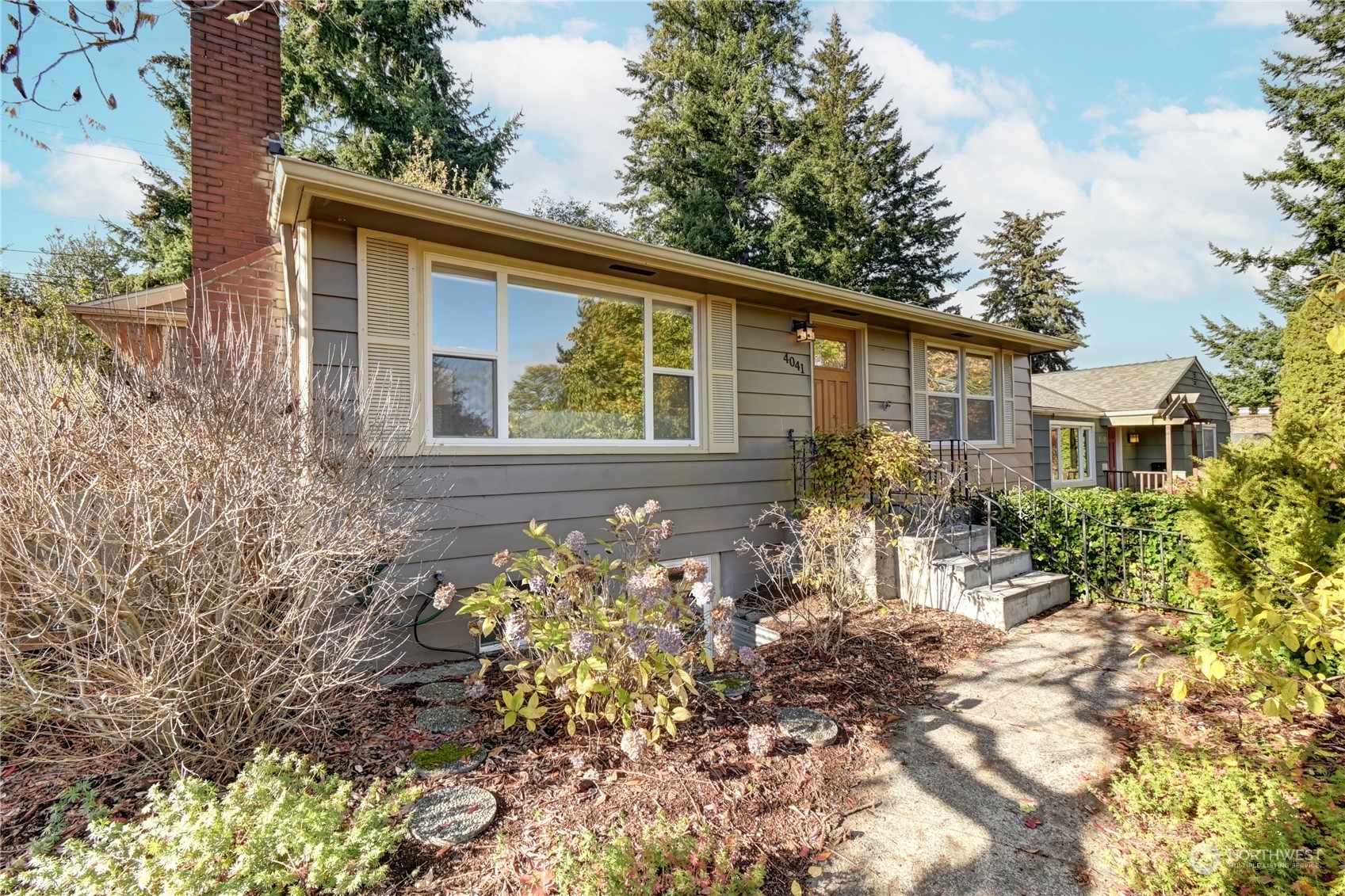 4041 48th Avenue Southwest Seattle, WA 98116 - Photo 1 of 28 a front view of a house with a yard