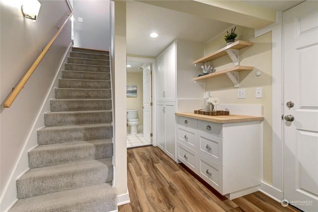 a view of entryway and hall with wooden floor