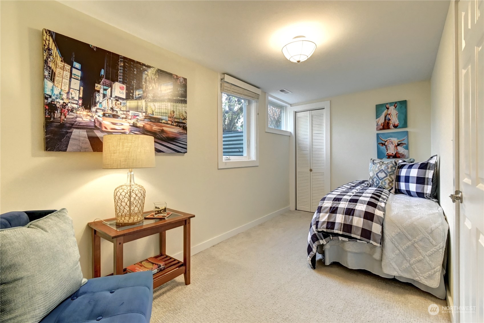 4041 48th Avenue Southwest Seattle, WA 98116 - Photo 17 of 28 a bedroom with a bed and wooden floor