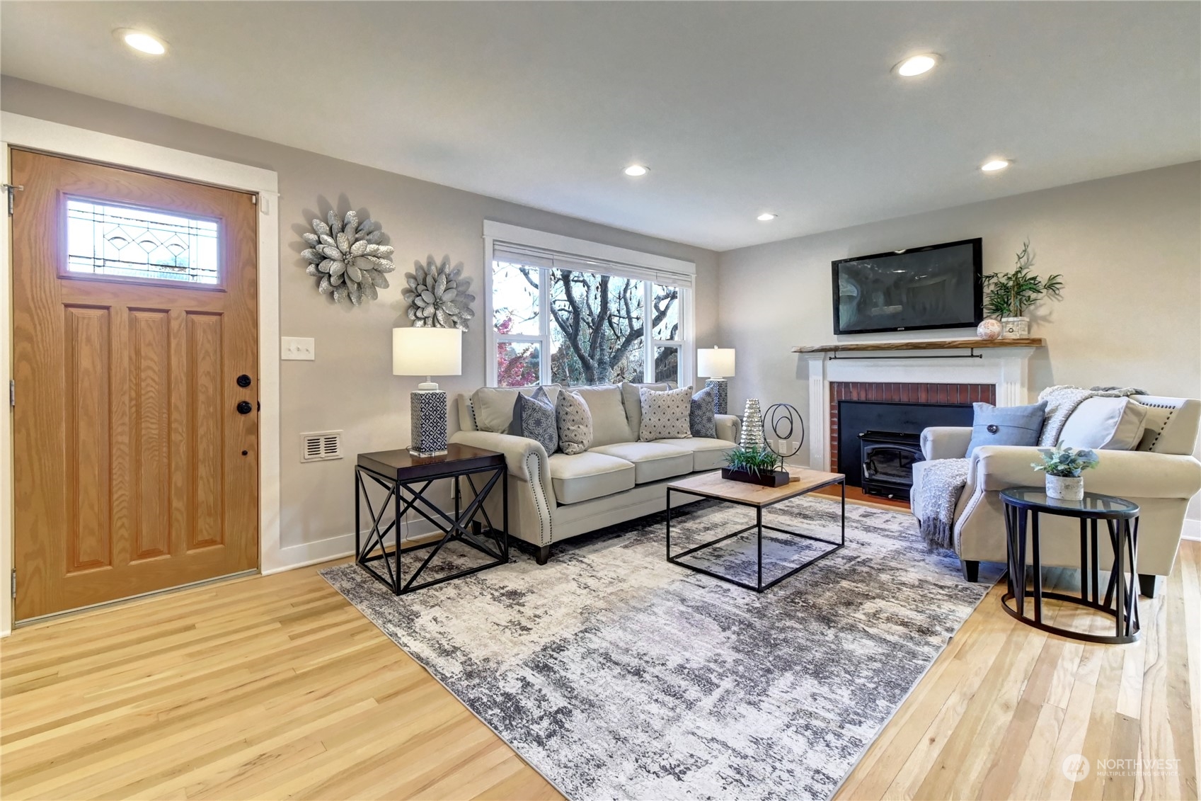 4041 48th Avenue Southwest Seattle, WA 98116 - Photo 2 of 28 a living room with furniture a flat screen tv and a fireplace