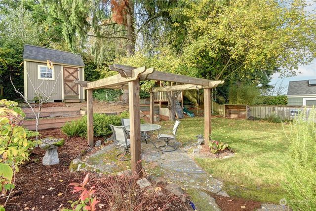 a view of a house with backyard and sitting area