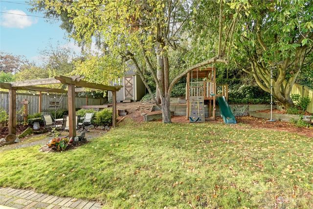 a view of a house with backyard and sitting area
