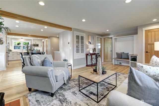 a living room with furniture and view of kitchen