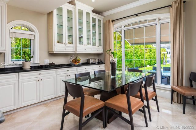 a dining room with furniture and a window