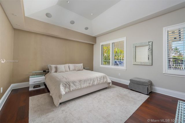 a bedroom with a bed couch and window