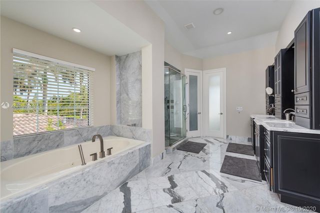 a spacious bathroom with a granite countertop sink a toilet and shower