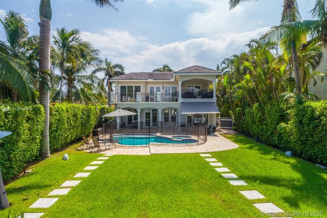 a view of a house with a yard patio and sitting area