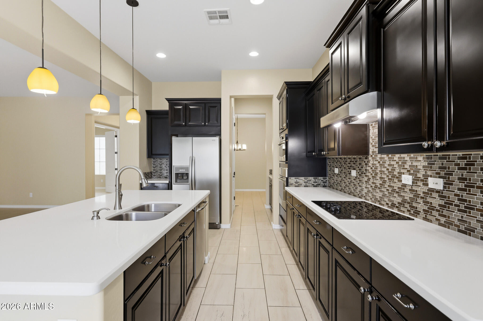 20441 West Hamilton Street Buckeye, AZ 85396 - Photo 17 of 88 a kitchen with stainless steel appliances a sink stove and refrigerator