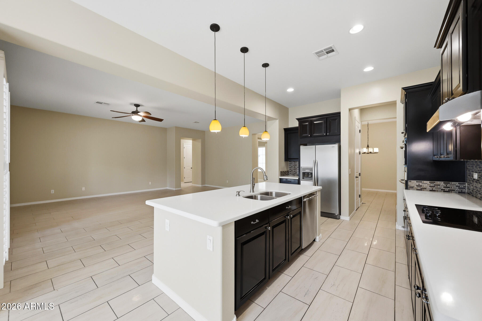 20441 West Hamilton Street Buckeye, AZ 85396 - Photo 18 of 88 a kitchen with kitchen island a sink stove and refrigerator