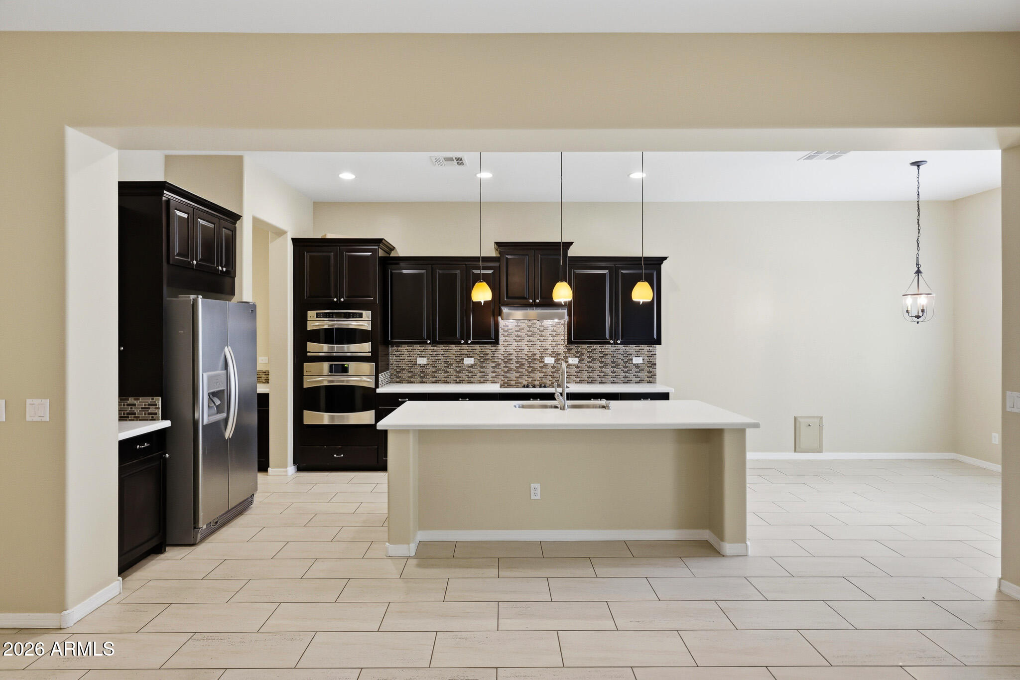 20441 West Hamilton Street Buckeye, AZ 85396 - Photo 21 of 88 a view of kitchen with stainless steel appliances kitchen island granite countertop a refrigerator and a stove top oven