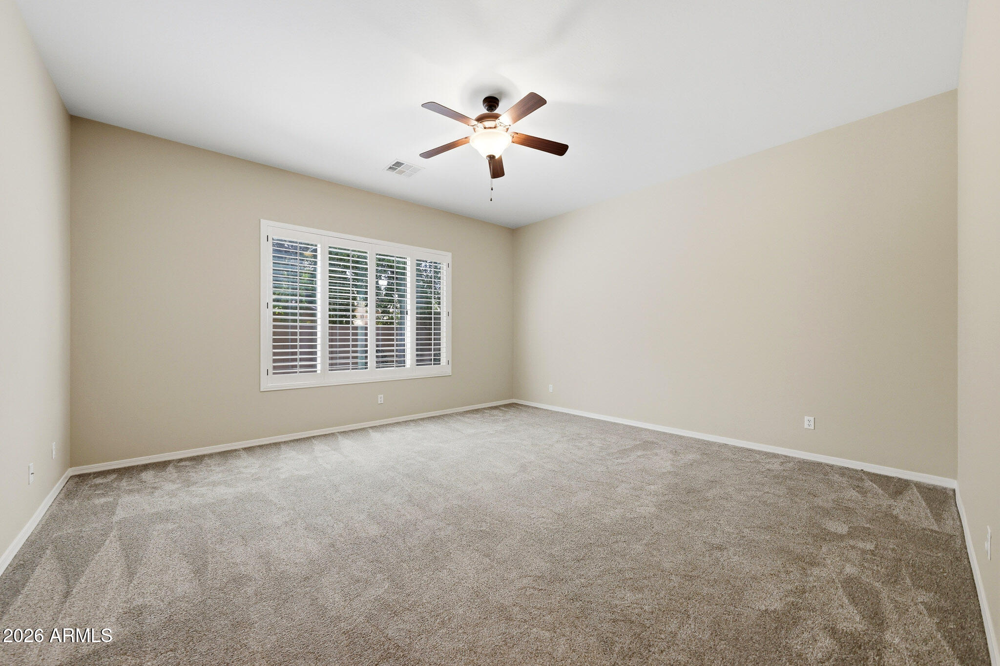 20441 West Hamilton Street Buckeye, AZ 85396 - Photo 24 of 88 an empty room with windows and ceiling fan