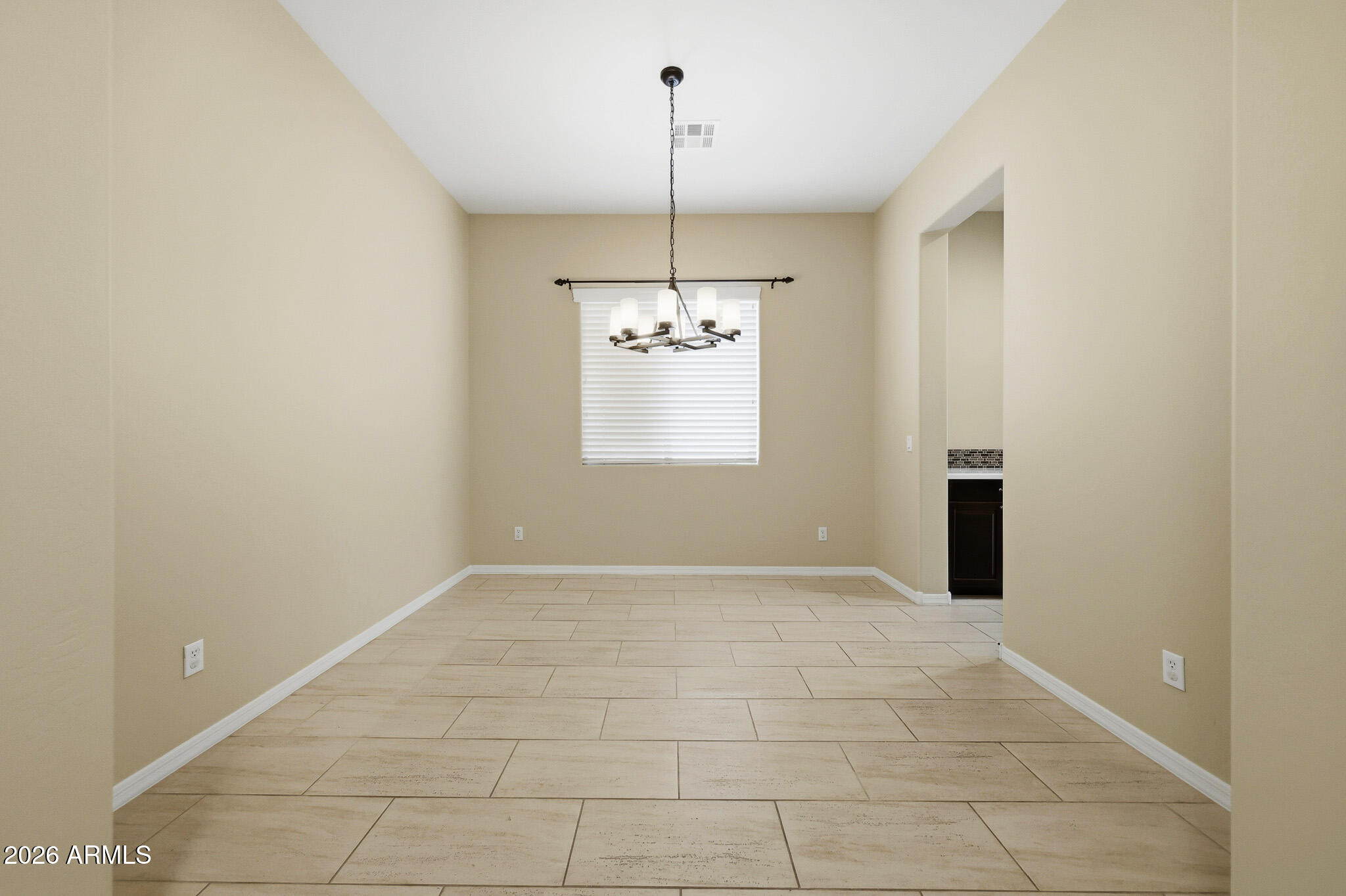20441 West Hamilton Street Buckeye, AZ 85396 - Photo 8 of 88 a view of an empty room and window chandelier fan