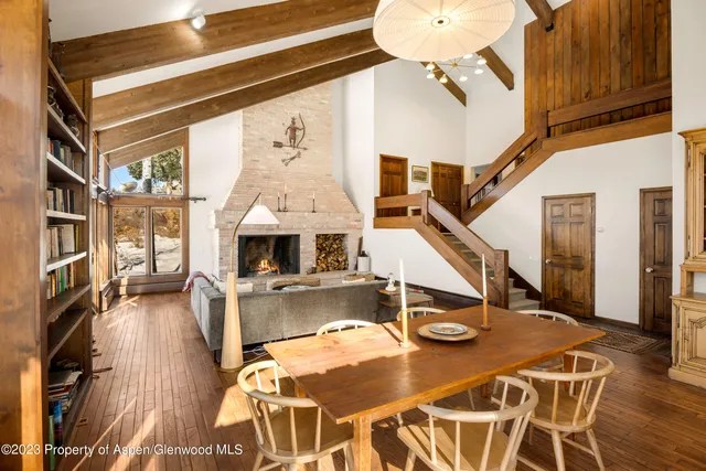 a living room with furniture a wooden floor and a chandelier