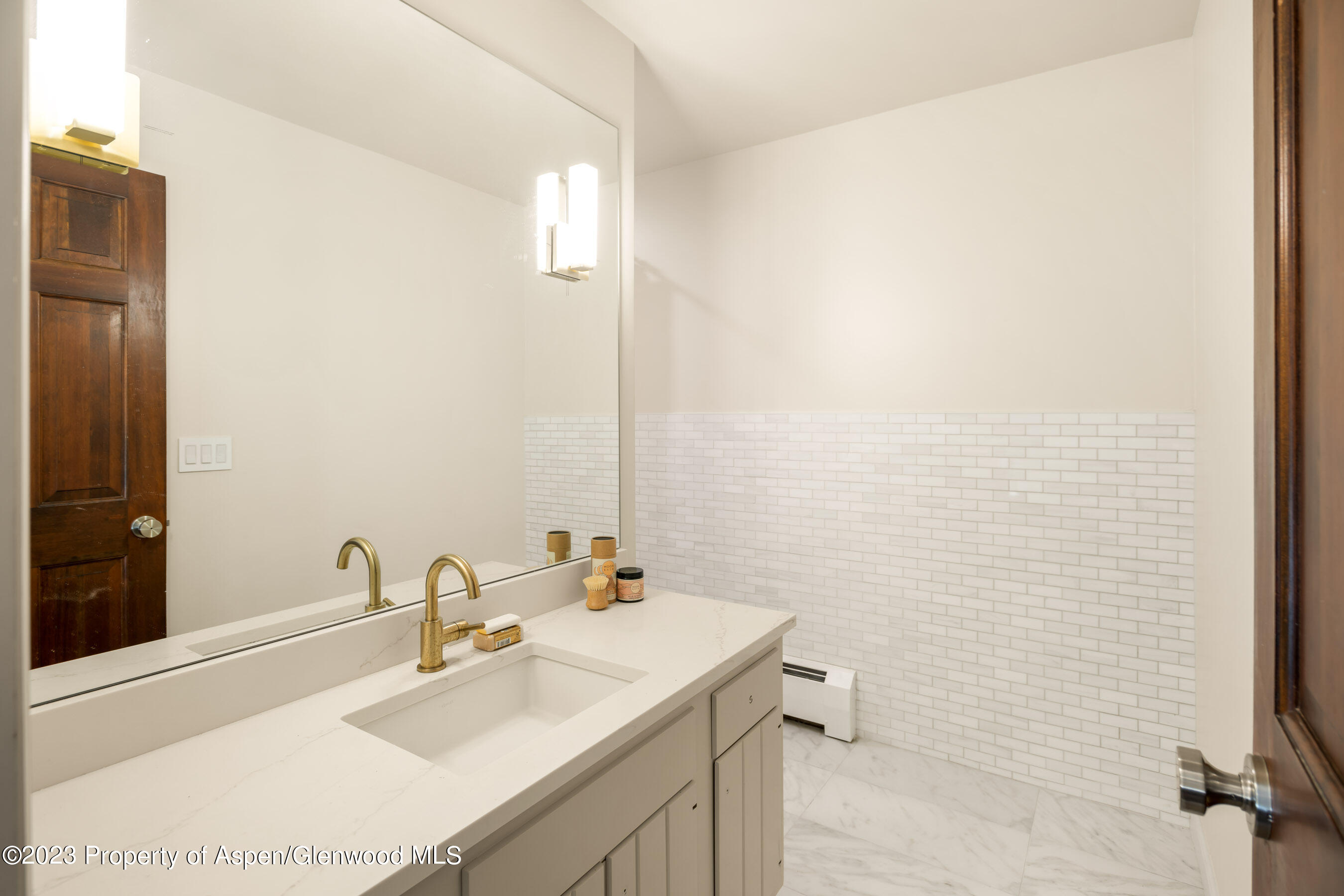 1036 Red Mountain Road Aspen, CO 81611 - Photo 14 of 37 a bathroom with a sink a toilet and mirror